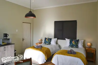 a bedroom with two beds with towels on them at Uitzicht in Dullstroom