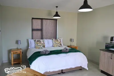 a bedroom with a bed with towels on it at Uitzicht in Dullstroom