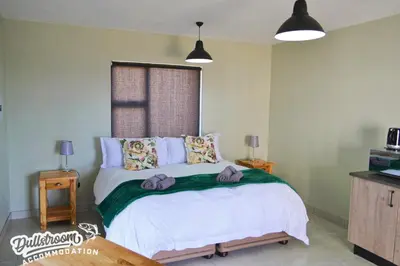 a bedroom with a bed with purple towels on it at Uitzicht in Dullstroom
