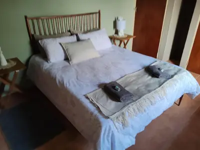 a bedroom with a large bed with a hat on it at 83 on De Lange in Graskop