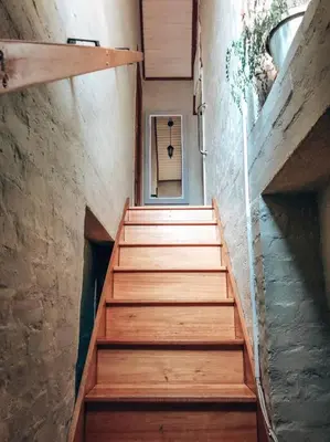 a staircase with wooden steps in a building at Eden Rain in Dullstroom