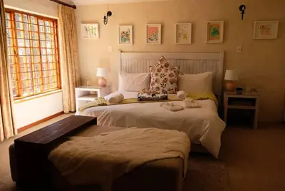 a bedroom with two beds with stuffed animals on them at Eden Rain in Dullstroom