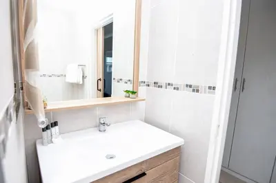 a bathroom with a white sink and a mirror at Unit 416 at Menlyn Place in Pretoria