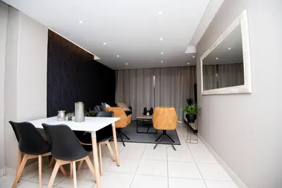 a dining room with a table and chairs at Unit 416 at Menlyn Place in Pretoria