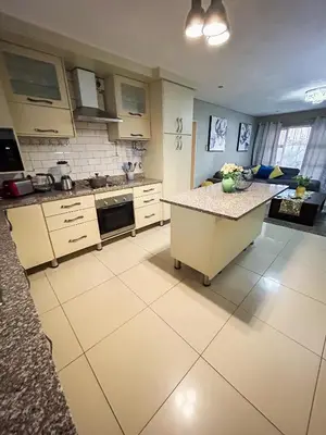 a kitchen with a island in the middle of it at Mjejane Debs guest house in Hectorspruit
