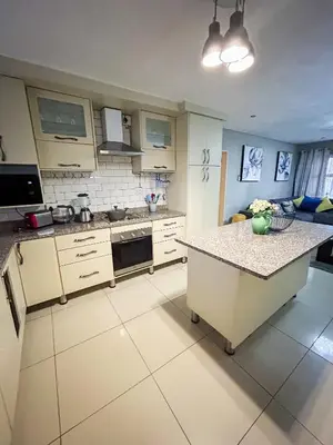 a kitchen with a island in the middle of it at Mjejane Debs guest house in Hectorspruit