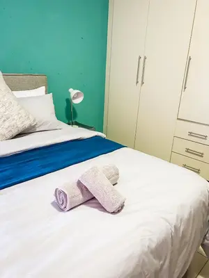 a bedroom with a bed with two towels on it at Mjejane Debs guest house in Hectorspruit