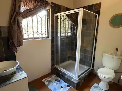 a bathroom with a shower and a toilet and a sink at Hakuna Matata-Bela Bela in Moheme