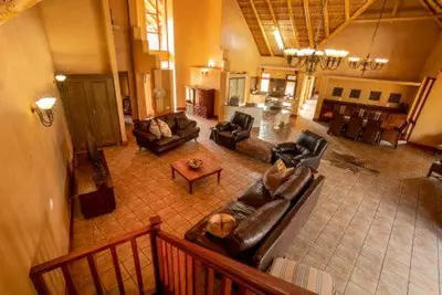 a large living room with couches and a table at 23 Zebula - 4 Bedroom 14 Sleeper Home in Mabula