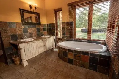a large bathroom with a tub and two sinks at 23 Zebula - 4 Bedroom 14 Sleeper Home in Mabula
