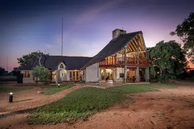 a large house with a gambrel roof at 23 Zebula - 4 Bedroom 14 Sleeper Home in Mabula