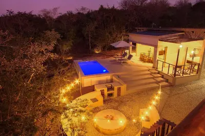 an aerial view of a house with a swimming pool at MRLTH Luxury Safari Villa, Close to KNP, Giraffe-Feeding-Tower, Spa-Bath, Boma in Marloth Park