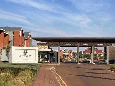 a building with a sign in the middle of a street at Luxury 1bed Serengeti OliveWood ORT Airport in Kempton Park
