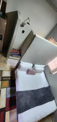 an attic bedroom with two beds in a room at Mountain Vue in Hartbeespoort