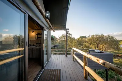 a view from the deck of a house with a tub at Nkuhlu Tented Camp in Skukuza