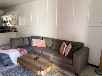 a living room with a couch and a coffee table at Siena Sun Luxury Suites 3 in Midrand