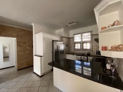a large kitchen with a black counter top at Siena Sun Luxury Suites 3 in Midrand