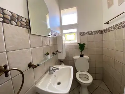 a bathroom with a toilet and a sink at Siena Sun Luxury Suites 3 in Midrand