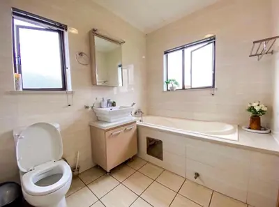 a bathroom with a tub and a toilet and a sink at Siena Sun Apartment 6 with water reserve in Midrand