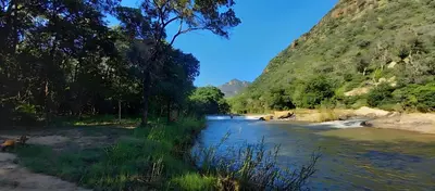 a view of a river with trees and a mountain at House On Blyde in Kampersrus AH