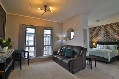 a living room with a couch and a bed at Luxury Lowveld Apartment in Nelspruit