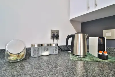 a kitchen counter with several appliances on a counter top at Luxury Lowveld Apartment in Nelspruit