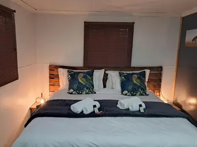 a bedroom with a bed with two towels on it at Sable Sunset Guesthouse in Trichardt