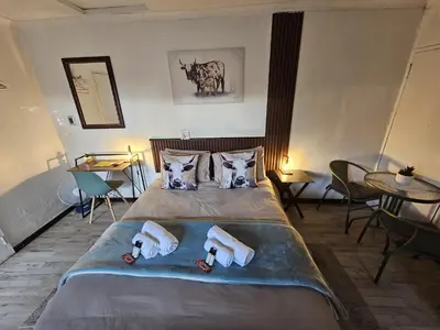 a bedroom with a bed with two dolls on it at Sable Sunset Guesthouse in Trichardt
