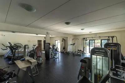 a gym with several treadmills and exercise bikes at The Sunrise in Midrand