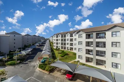 an aerial view of an apartment complex with a parking lot at The Sunrise in Midrand