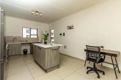 a kitchen with a desk and a chair in a room at The Grandeur- with back up power in Midrand