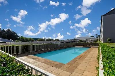 a swimming pool with a fence around it at The Grandeur- with back up power in Midrand