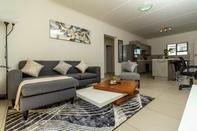 a living room with a couch and a table at The Grandeur- with back up power in Midrand