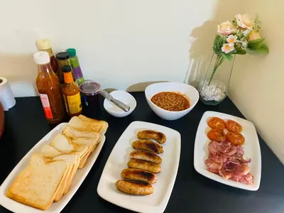 a table with two plates of food with bread and sausages at Siena Sun Guesthouse Rooms and Breakfast Option in Midrand