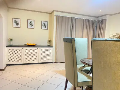 a living room with a table and a dining room at Siena Sun Guesthouse Rooms and Breakfast Option in Midrand