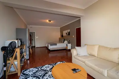 a living room with a couch and a table at Somethin Special in Mokopane