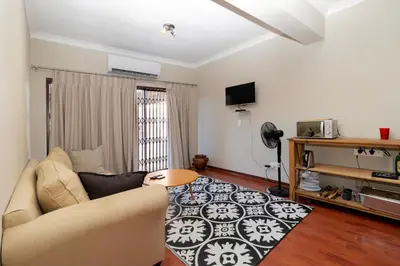 a living room with a couch and a table at Somethin Special in Mokopane