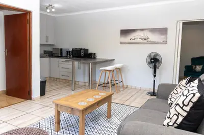 a living room with a couch and a table at Somethin Special in Mokopane