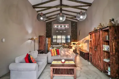a living room with two couches and a coffee table at NoNaMe in Marloth Park