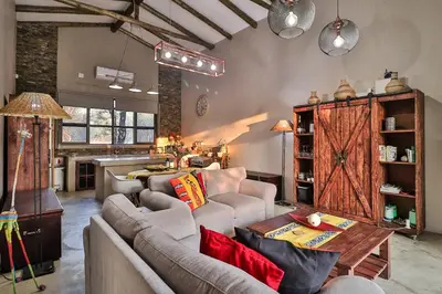a living room with a couch and a table at NoNaMe in Marloth Park