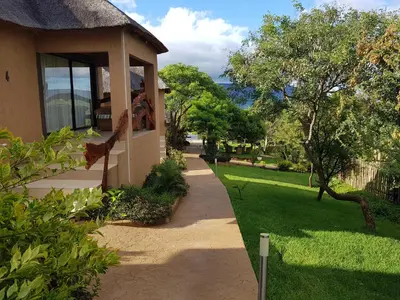 a walkway next to a house with a yard at The Elias Resort in Septimus