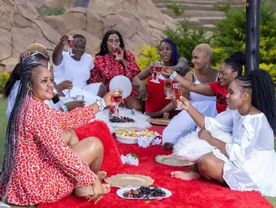 a group of women sitting on a blanket drinking wine at The Elias Resort in Septimus