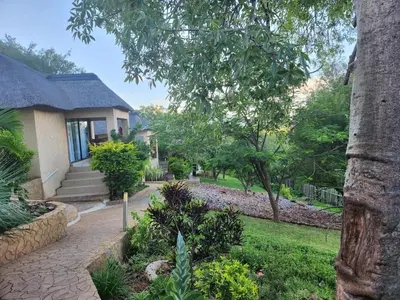 a house with a walkway in front of a yard at The Elias Resort in Septimus