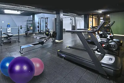 a gym with a treadmill and some exercise equipment at Circa Aparthotel by Totalstay in Pretoria