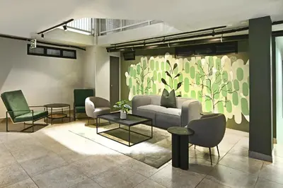 a living room with a couch and chairs at Circa Aparthotel by Totalstay in Pretoria