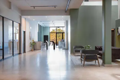 an empty lobby with chairs and tables in a building at Circa Aparthotel by Totalstay in Pretoria
