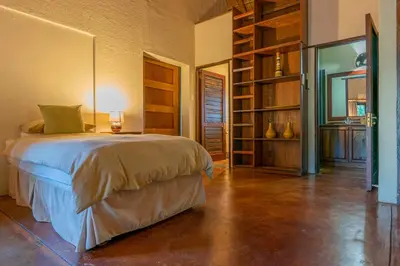 a bedroom with a bed and a book shelf at Impisi Accommodation in Phalaborwa