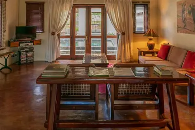 a living room with a table and a couch at Impisi Accommodation in Phalaborwa