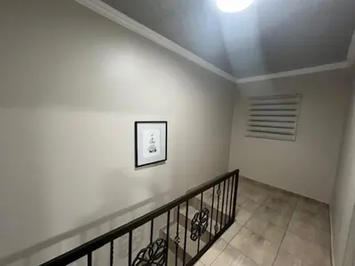 a staircase in a house with a picture on the wall at Tintswalo Elegant Apartments in Giyani