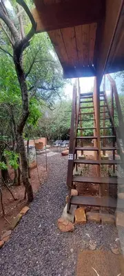 a staircase leading up to a building with a tree at Hartbeest Bush Stay #3 in Hartbeespoort